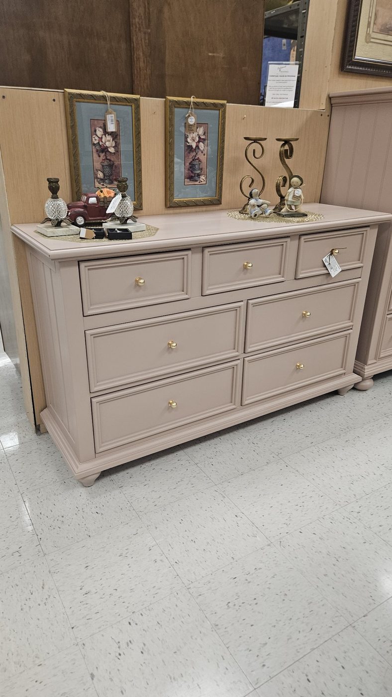 Pink refinished seven-drawer dresser with gold knobs